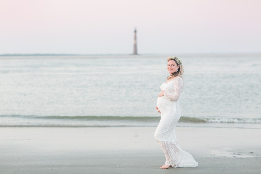 Mother to be in front of the Morris Island Lighthouse on Folly beach, South Carolina. Beach Maternity.
