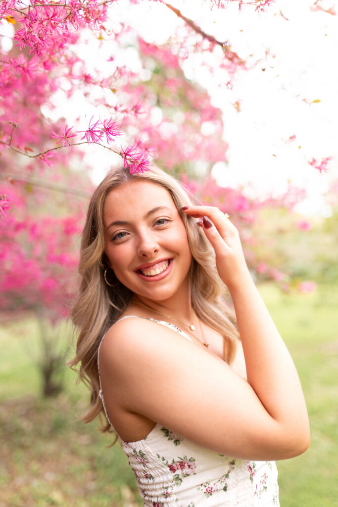 Charleston Senior Photographer capturing high school senior under blooming flowers at Hampton Park