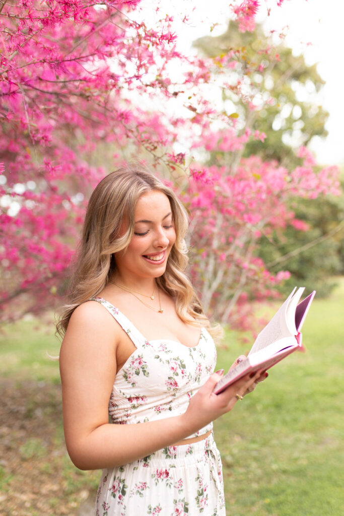 Charleston Senior Photographer capturing high school senior under blooming flowers at Hampton Park