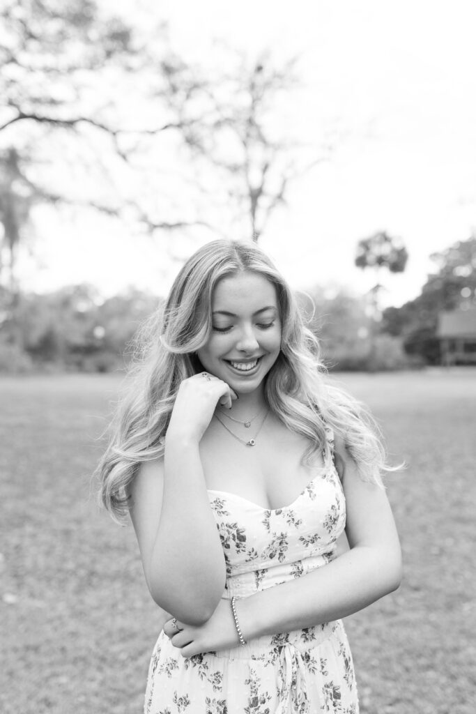 Charleston Senior Photographer capturing high school senior in open field at Hampton Park