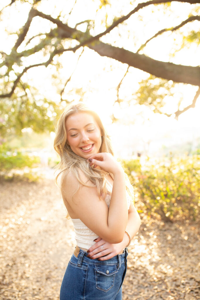 Charleston Senior Photographer capturing high school senior under Spanish Moss at Hampton Park