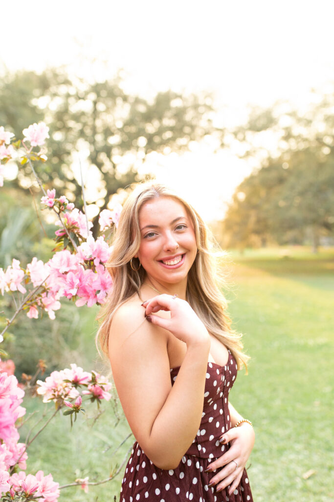 Charleston Senior Photographer capturing high school senior next to blooming flowers at Hampton Park