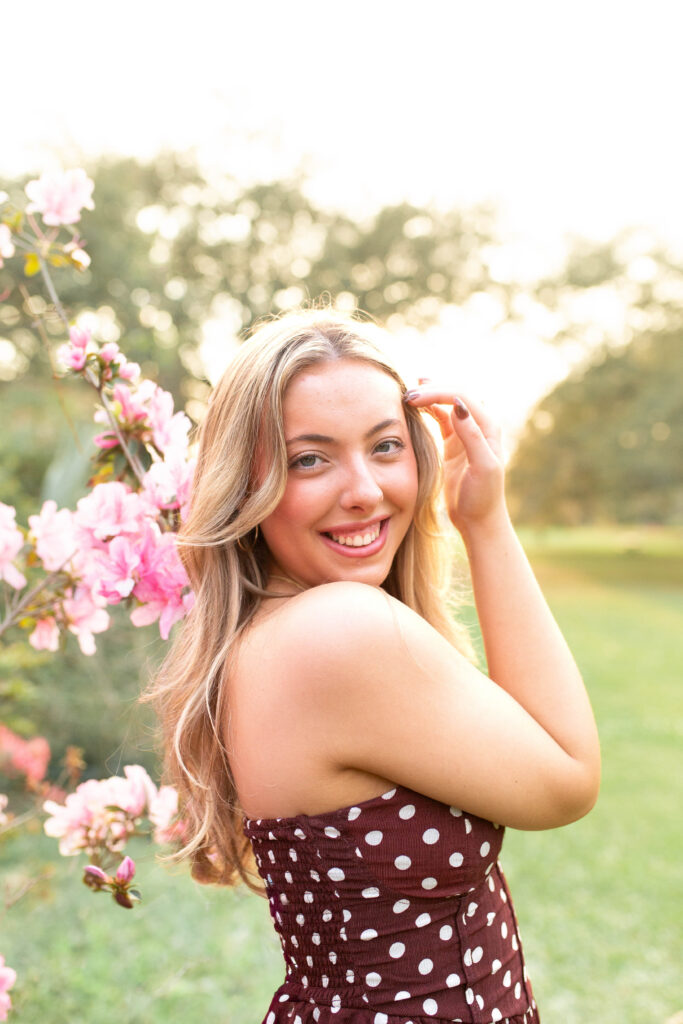 Charleston Senior Photographer capturing high school senior next to blooming flowers at Hampton Park