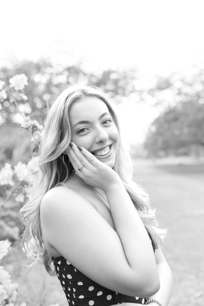 Charleston Senior Photographer capturing high school senior next to blooming flowers at Hampton Park