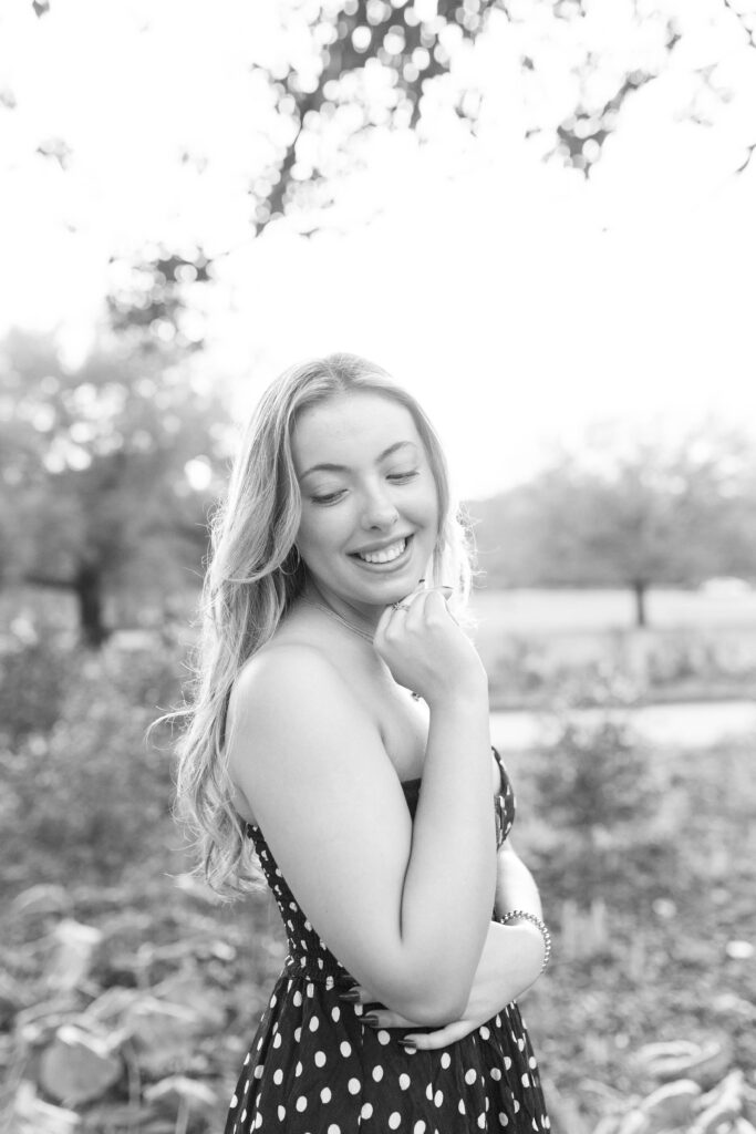 Charleston Senior Photographer capturing high school senior next to blooming flowers at Hampton Park