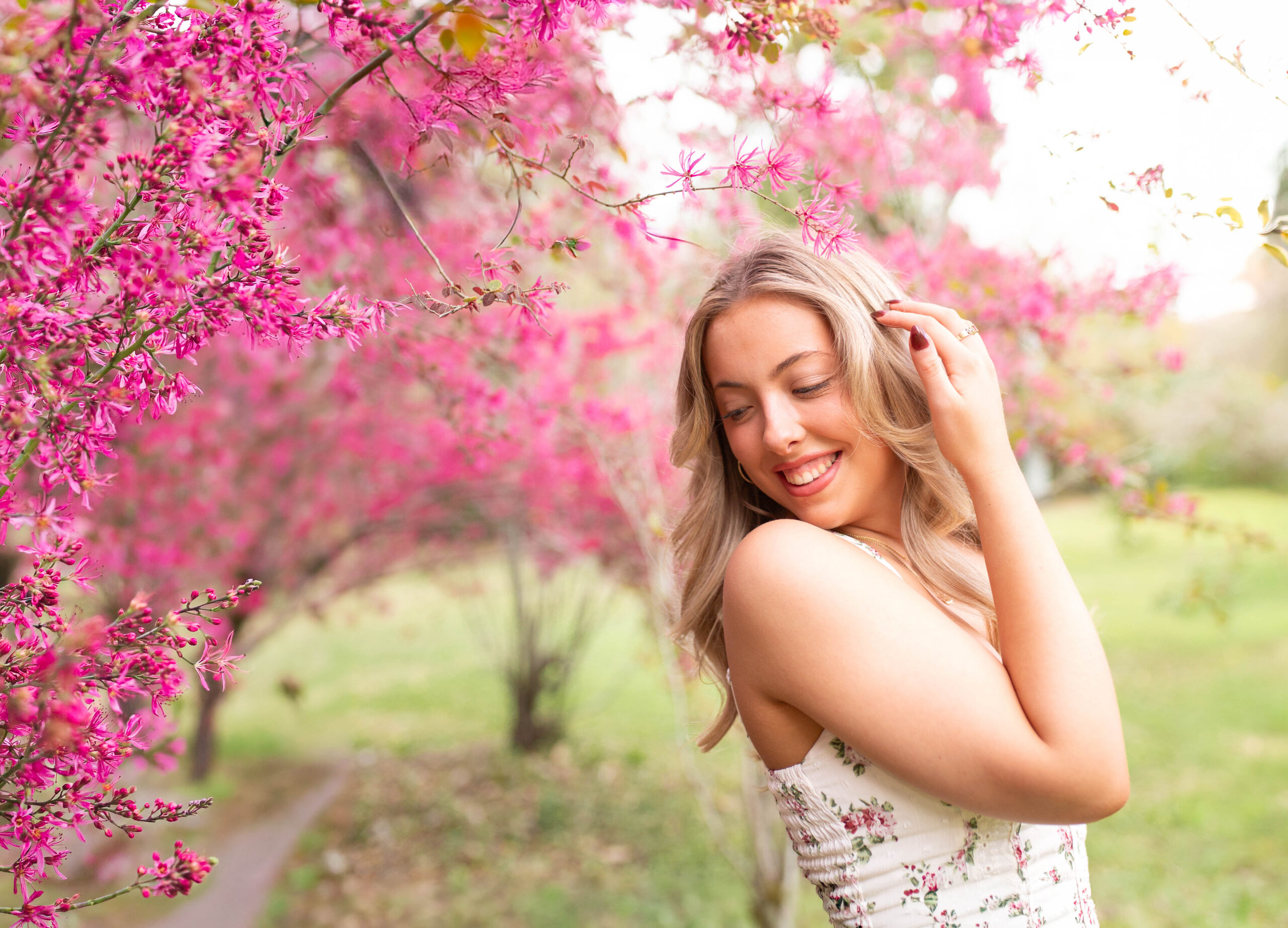 Charleston Senior Photographer capturing high school senior next to blooming flowers at Hampton Park