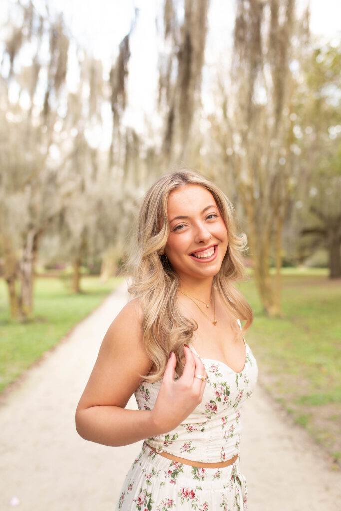 Charleston Senior Photographer capturing high school senior under Spanish Moss at Hampton Park