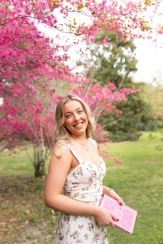 Charleston Senior Photographer capturing high school senior under blooming flowers at Hampton Park