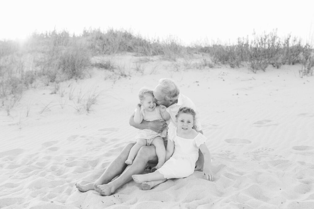 Grandfather on the beach with his grandchildren during an extended family session