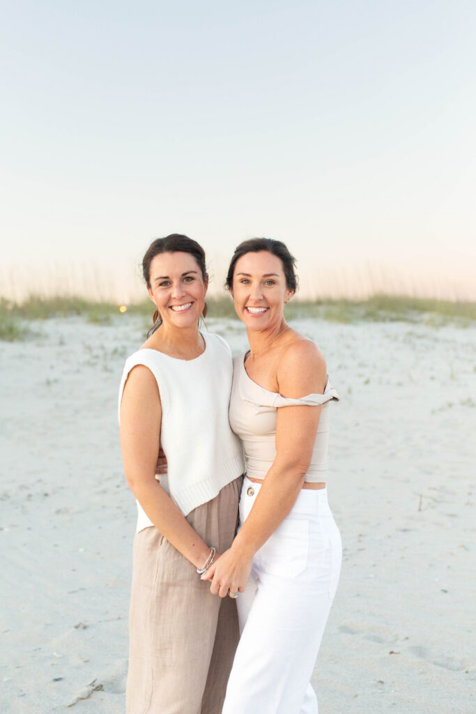 Adult sisters on the beach at sunset