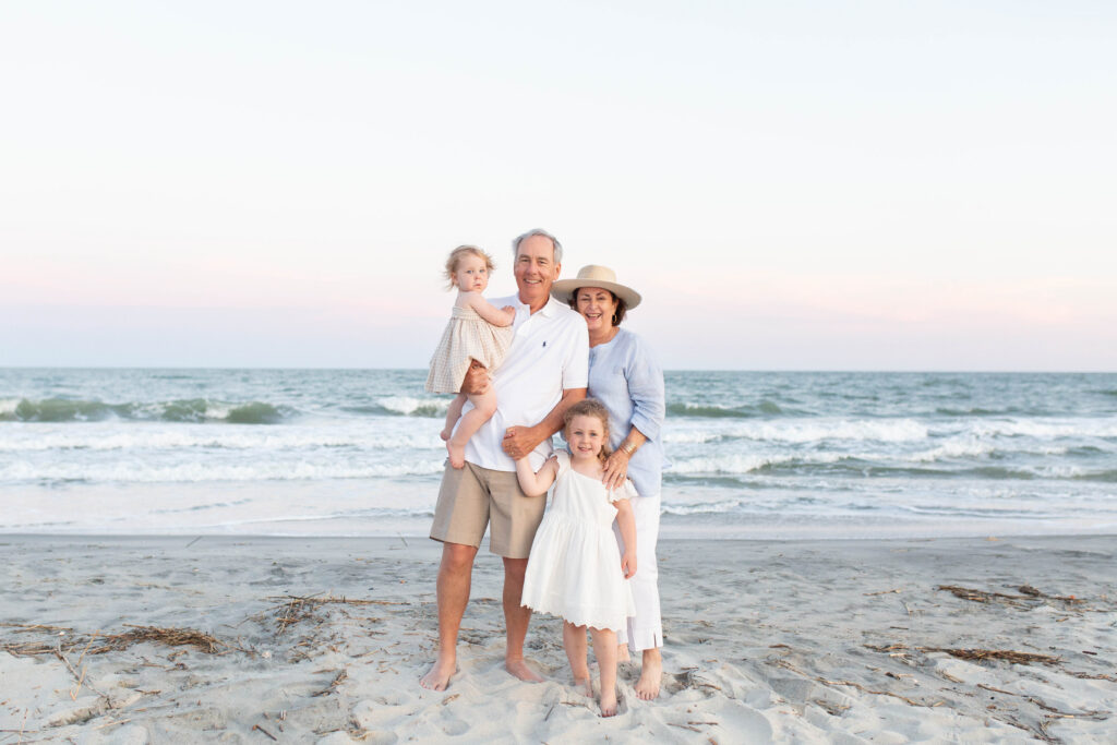 Grandparents on the beach with their grandchildren during an extended family session