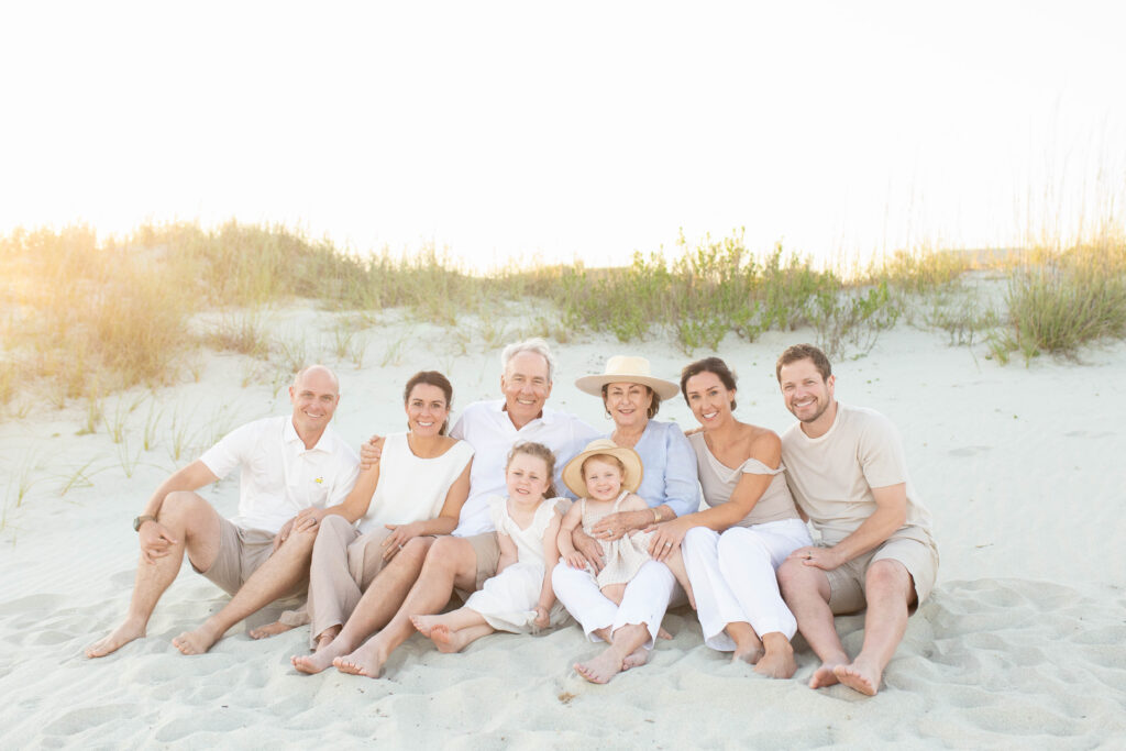 Extended Family sitting in the sand at sunset